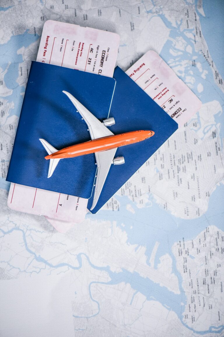 composition of flight tickets with toy airplane laying on map