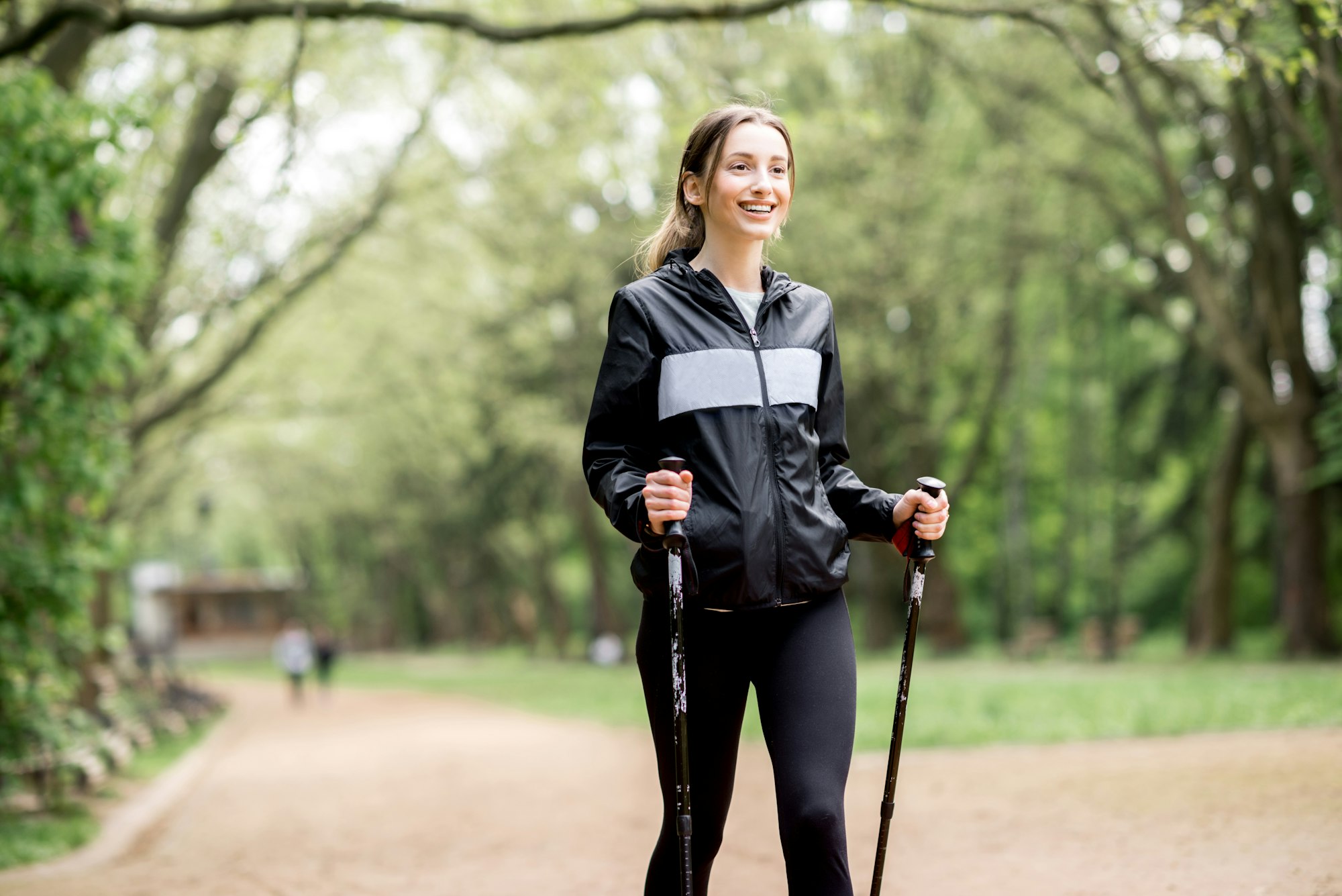 Woman walking with hiking sticks